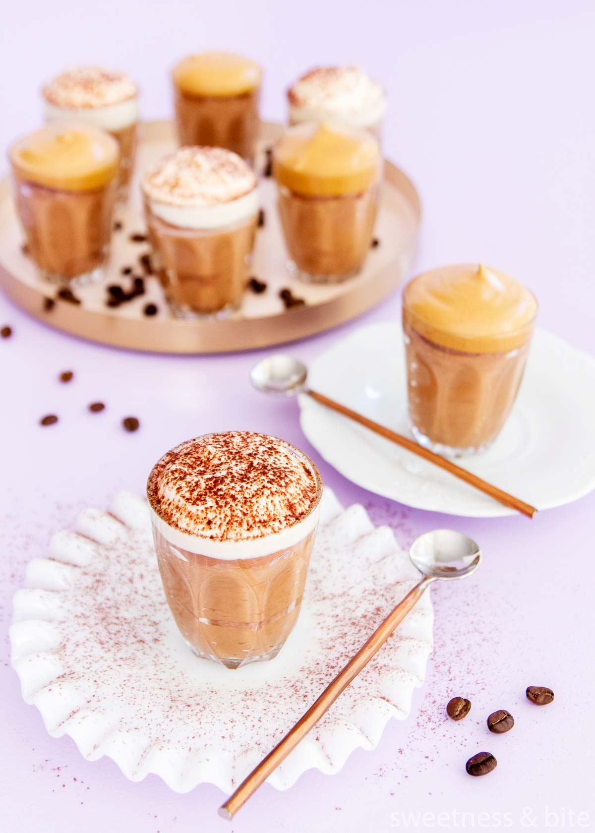 Overhead image of the mocha mousses, on a pale purple background, with scattered coffee beans.