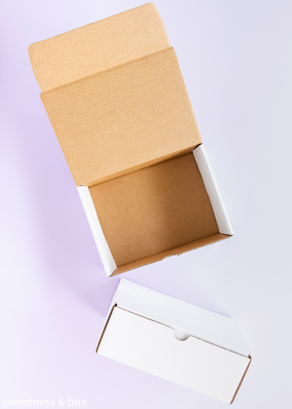 Two small white hinged-lid cardboard boxes.