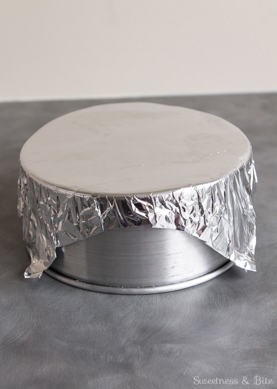 The foil square pressed over the bottom of a cake pan to make a 