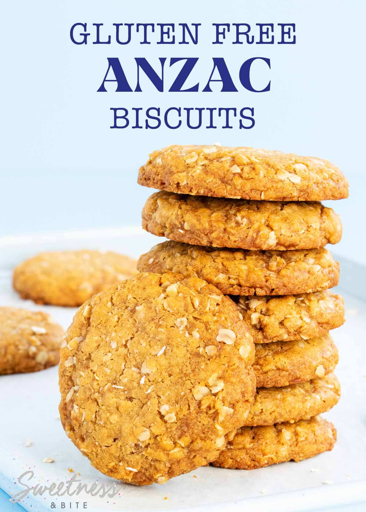 A stack of 7 gluten free Anzac biscuits on a blue background.