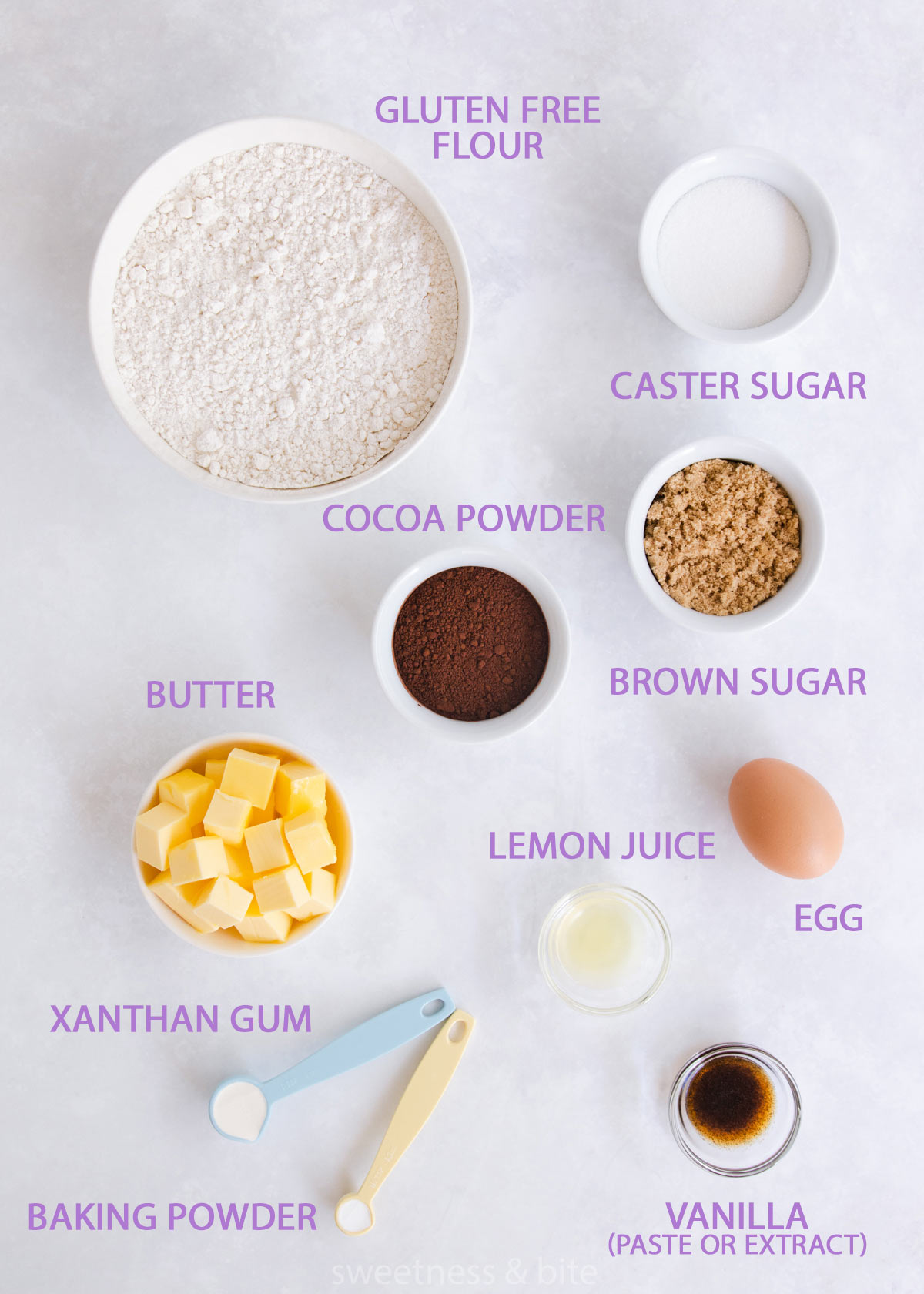 The gluten free chocolate cookie ingredients, in bowls on a grey background.