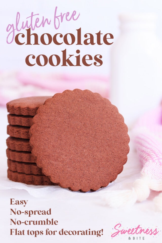 Stack of scalloped-edge round gluten free chocolate cookies, with one cookie resting on its side against the stack.