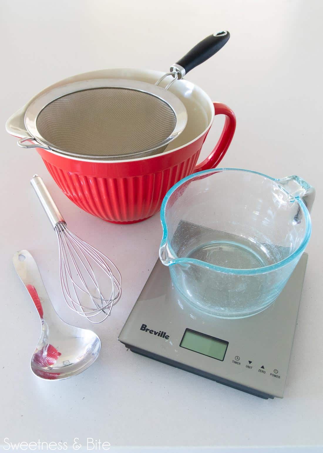 Tools for mixing up the flour blend - bowls, sieve, spoon, whisk and kitchen scales.