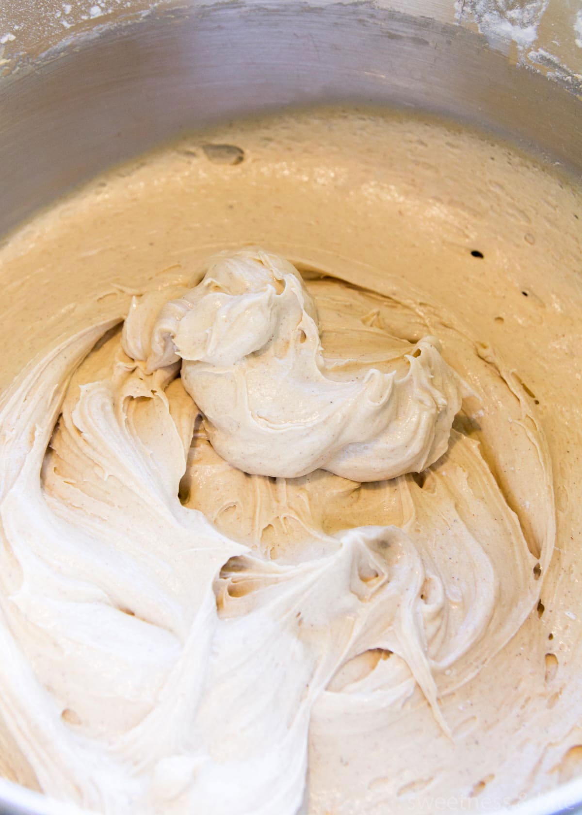 Fruit cake batter in a stainless steel bowl.