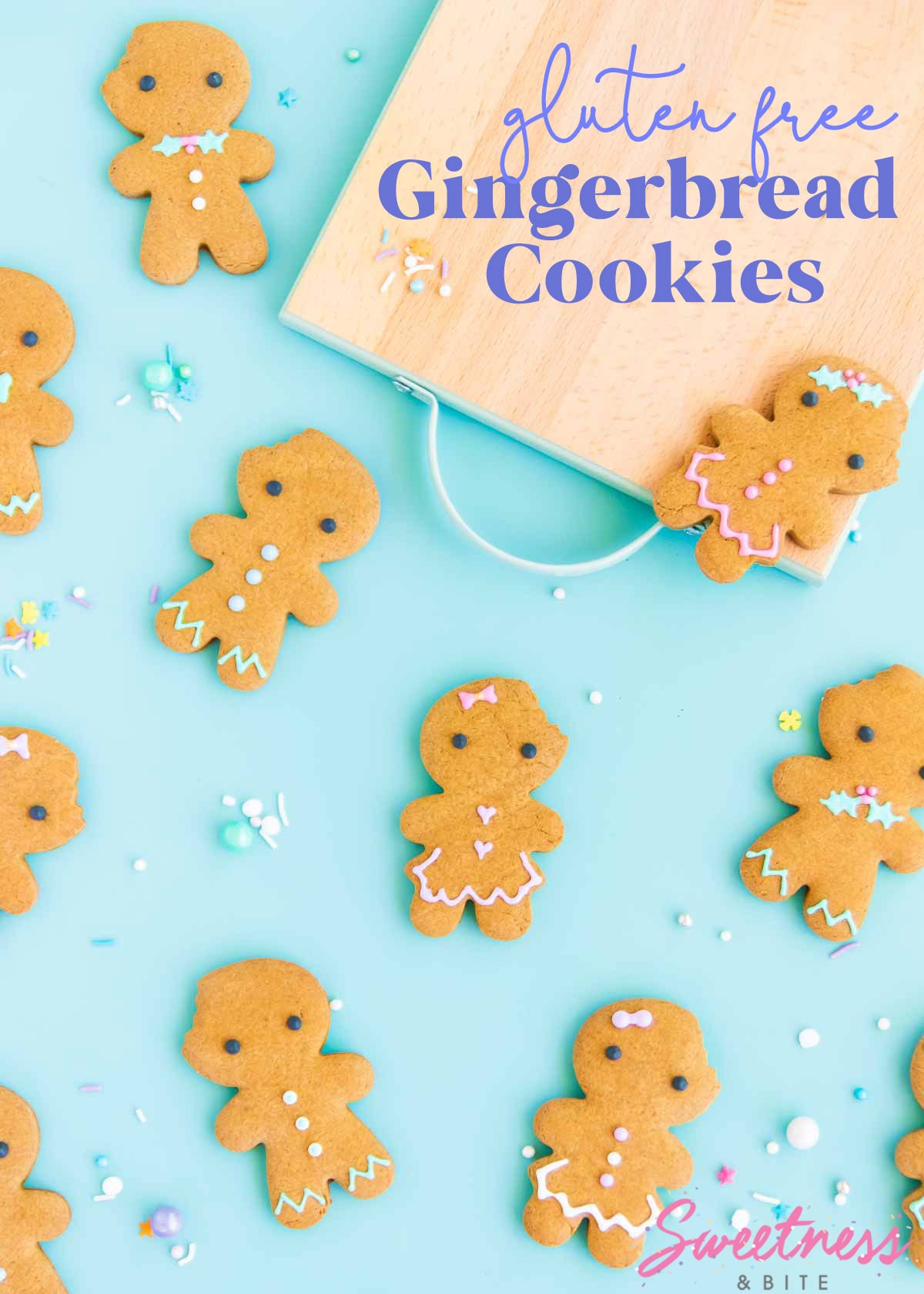 Gluten free gingerbread men and women cookies decorated with pastel royal icing, on a blue background.