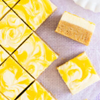 Square pieces of gluten free lemon slice on a pale purple background.