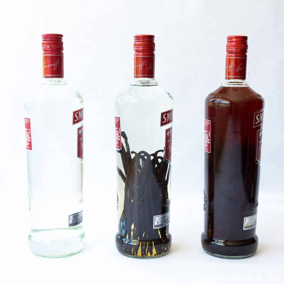 Three Smirnoff bottles, one with plain vodka, one with vanilla beans added, and one after the homemade vanilla extract has steeped.