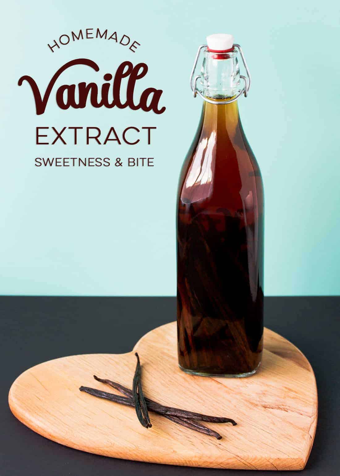 A bottle of vanilla extract on a heart shaped wooden board, text overlay reads: 