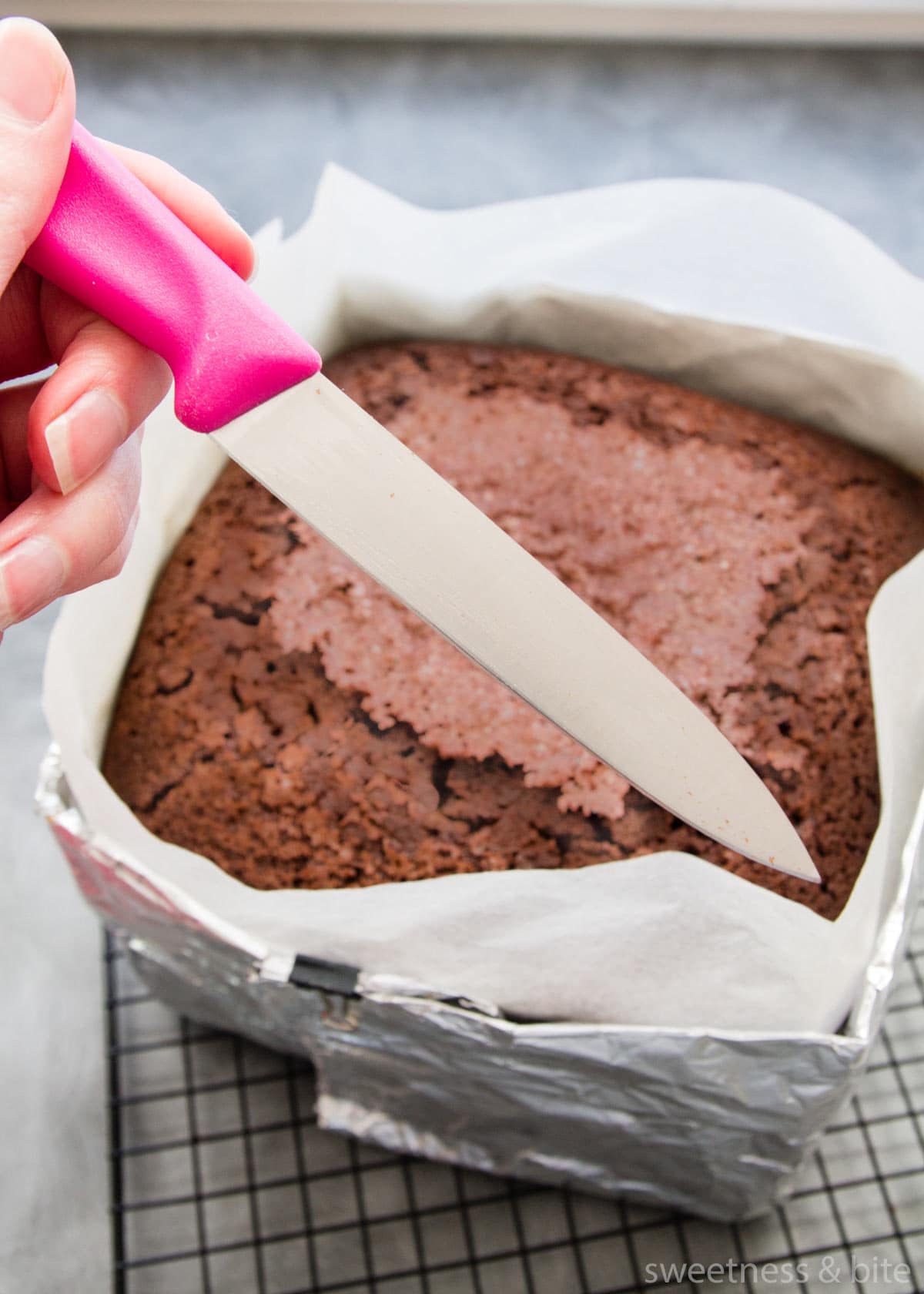 Using a knife to check if the cake is done.