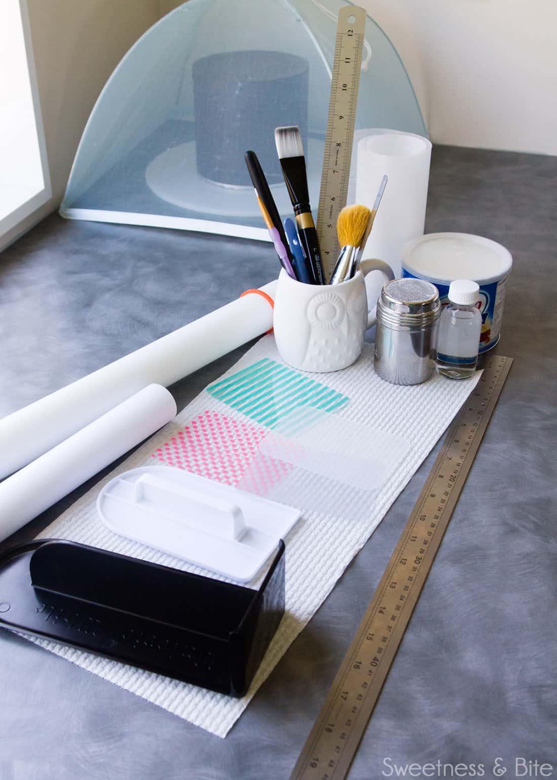 Cake decorating tools laid out on a kitchen counter. 