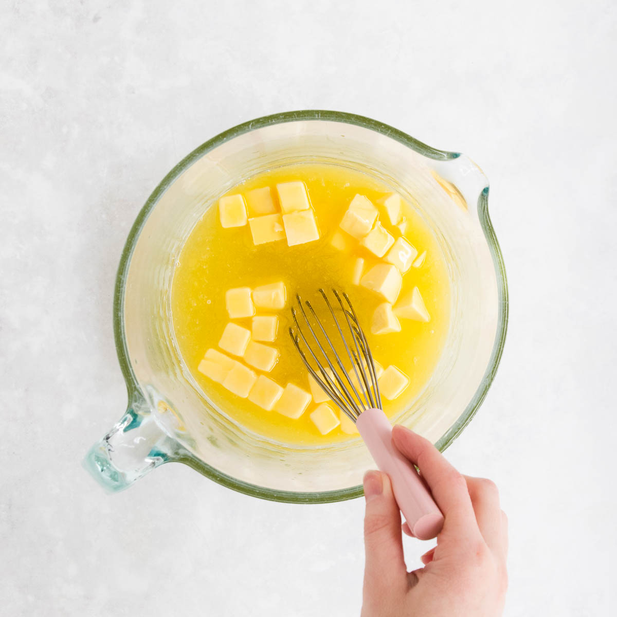 Butter being added to the lemon/sugar mixture, and stirred as it starts to melt.