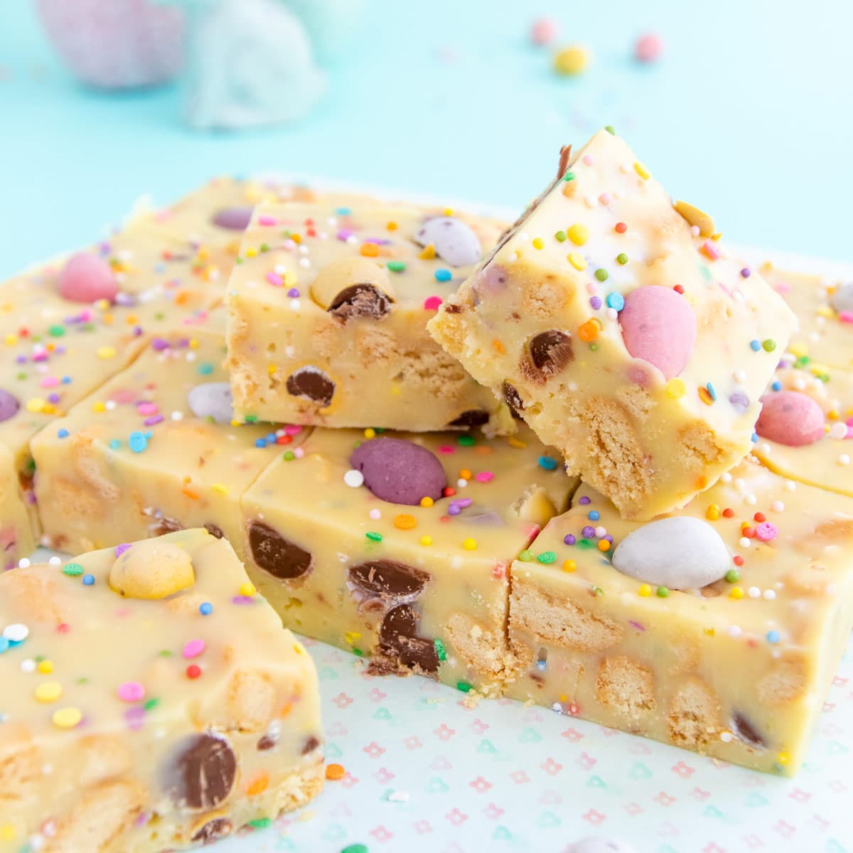 Two squares of fudge stacked on top of the remaining squares. 