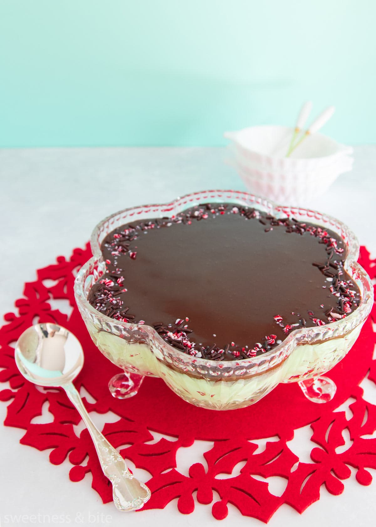 Mint mousse in a flower shaped cut glass bowl, topped with dark chocolate ganache and crushed candy canes. 