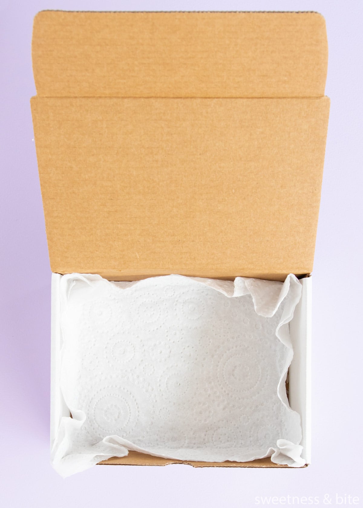 A box lined with a paper towel.