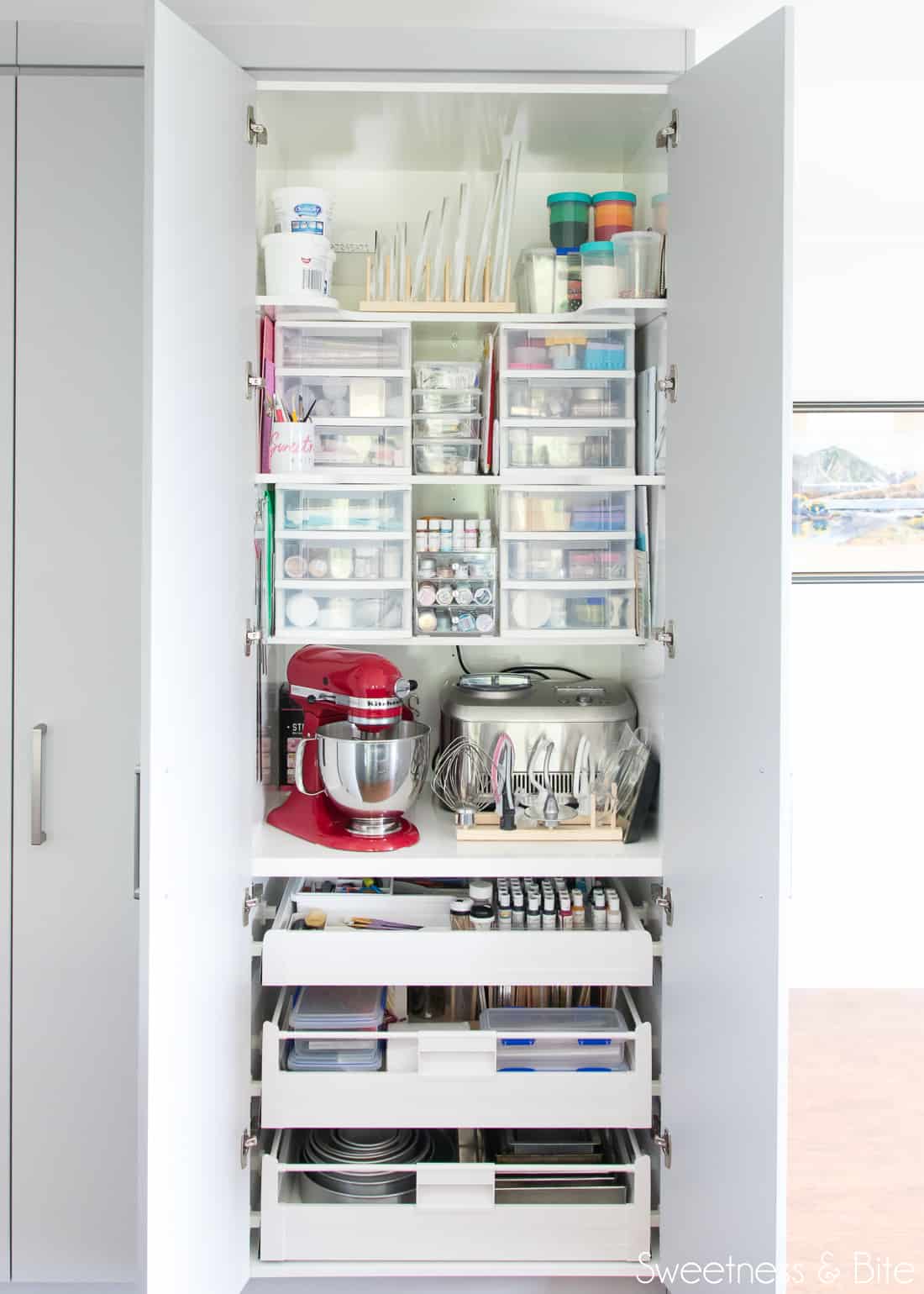 A large, floor-to-ceiling pantry filled with cake decorating supplies and tools. 