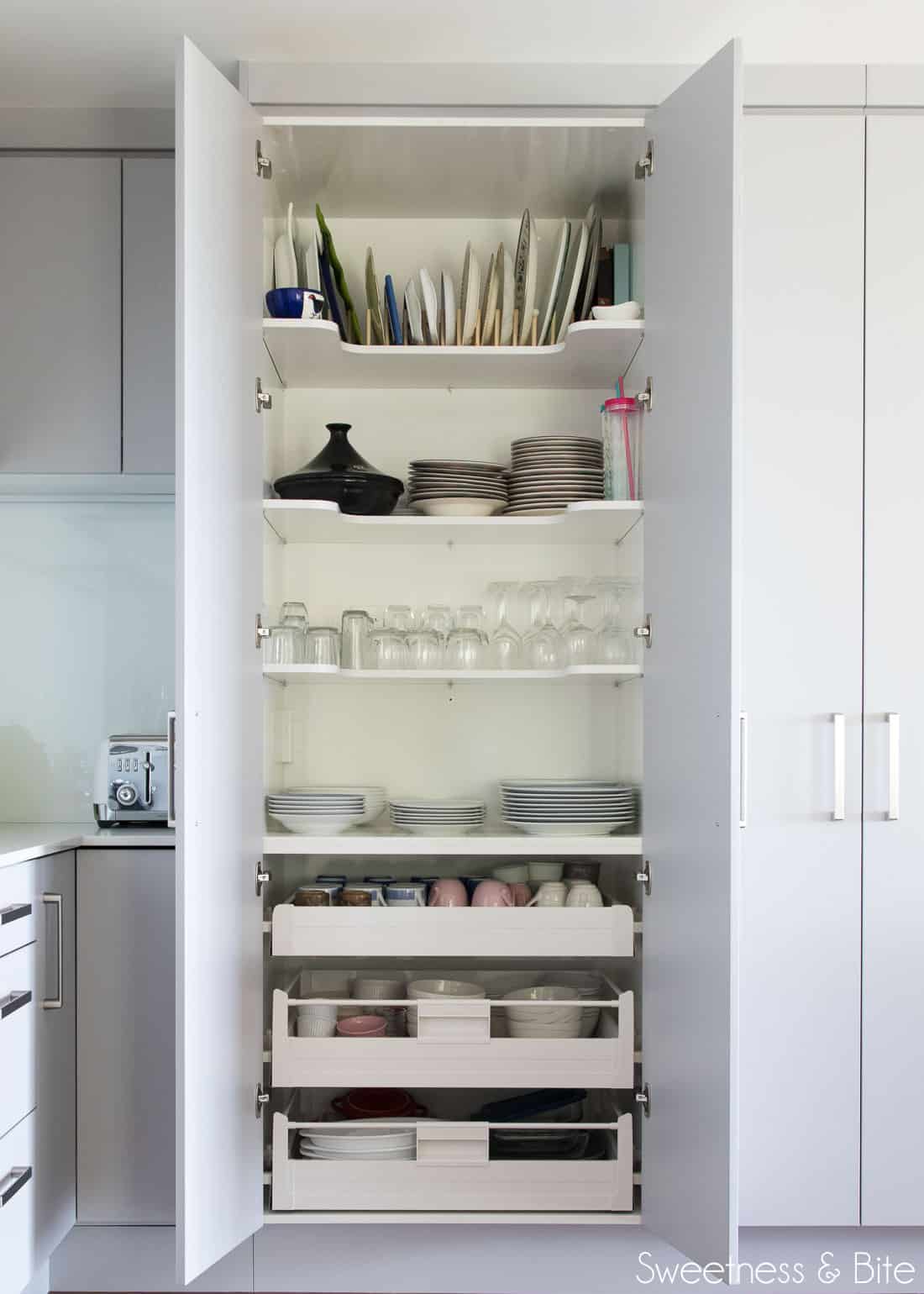 The inside of one of the large pantries, showing crockery and glassware.