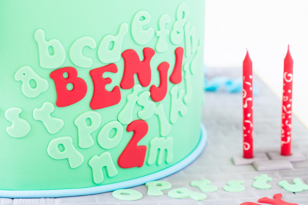 A bright green cake with red and green lettering attached to the front. Text reads: 
